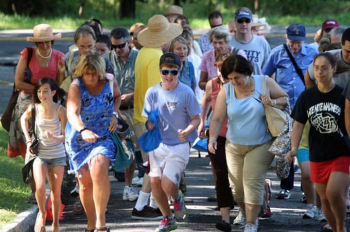 People from all over Westchester and neighboring communities run up the driveway at a previous annual fair/auction held by St. James Episcopal Church.