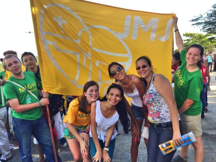 Fairfield University students Jennifer Salit (front row left, yellow tee shirt) and Jessica Estrada (far right, green tee shirt) celebrating Magis 2013 and World Youth Day in Brazil this month.