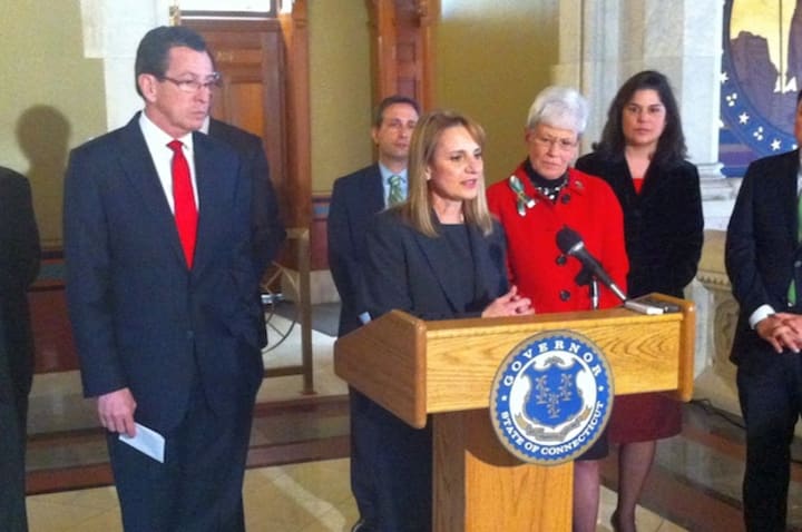 Evonne Klein, commissioner of the state Department of Housing, speaks as Gov. Dannel Malloy stands to her left. 