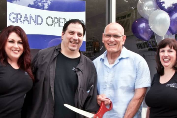 Honest Vapor owners Beth Nole (left), Luciano Manente (second from left), and Rosanna Manente (right) stand with Ron Belmont, Deputy Supervisor/Mayor Harrison, at last week&#x27;s grand opening of Honest Vapor.