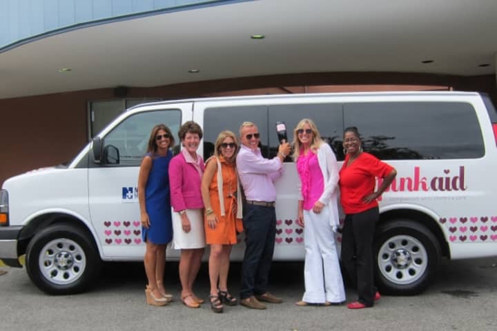 From left: Pink Aid Board Member 
Deb Placey; Norwalk Hospital Foundation President Mary Franco, Pink Aid Board Members Amy Gross, Andrew Mitchell-Namdar and Amy Katz and driver Robin Smith christen Norwalk&#x27;s new van for breast cancer screenings.