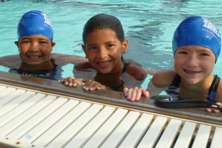 From left, young swimmers like Natalia Benejam, Alexa Benejam and Eva Cantalapiedra have participated in Swim Across America at the Lake Isle Club in Eastchester. 