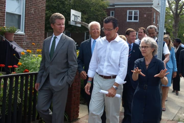 From right: Norwalk Housing Authority Deputy Director Candace Mayer leads Gov. Dannel Malloy, Mayor Richard Moccia, HUD Secretary Shaun Donovan and other officials on a tour of Washington Village in Norwalk.