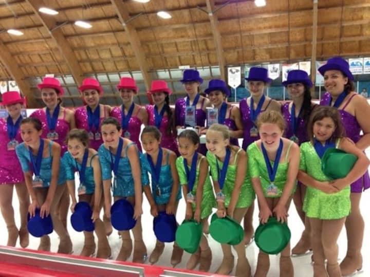 The members of the Danbury Ice Cabaret Ensemble celebrate with their gold medals in the Kaleidoskate category in Anaheim, Calif. 