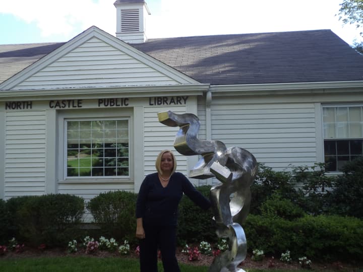 Diane DiDonato Roth stands in front of &quot;Why&quot;, a new sculpture at the North Castle Public Library, sculpted by Sean Landau.