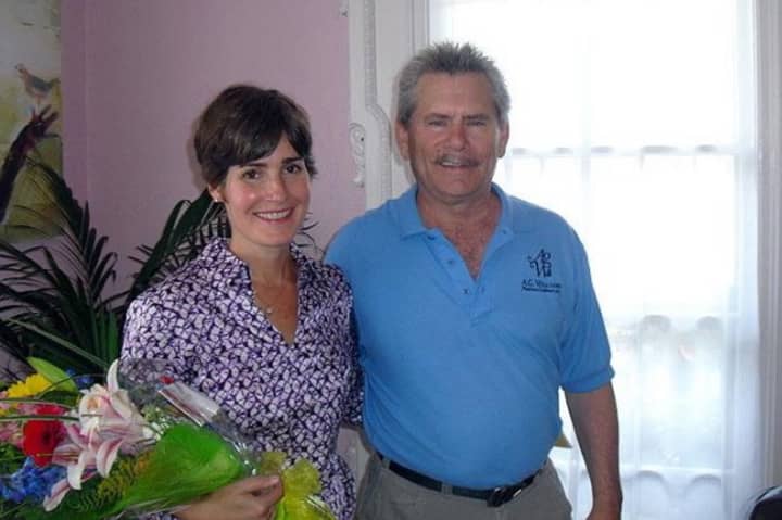 Carey Dougherty, Her Haven founder and executive director and Doug Kitchen, Fairfield account representative, A.G. Williams Painting Company stand in a renovated Bridgeport home.