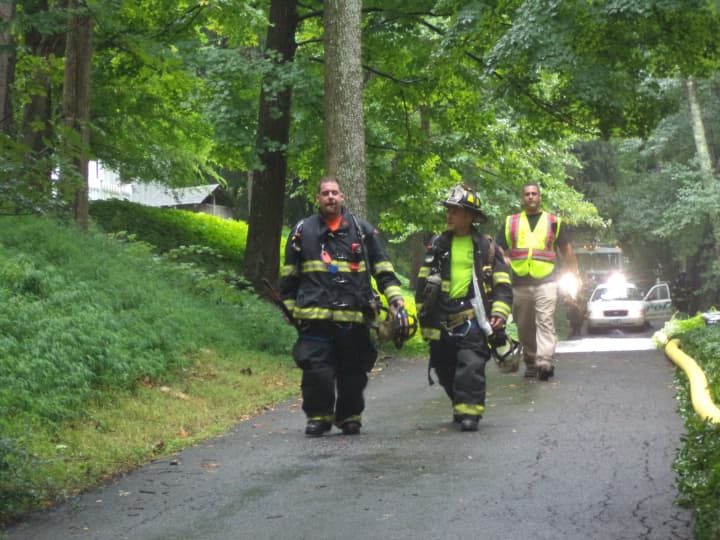 Bedford firefighters leaving the scene after battling a propane fire on Old Post Road.