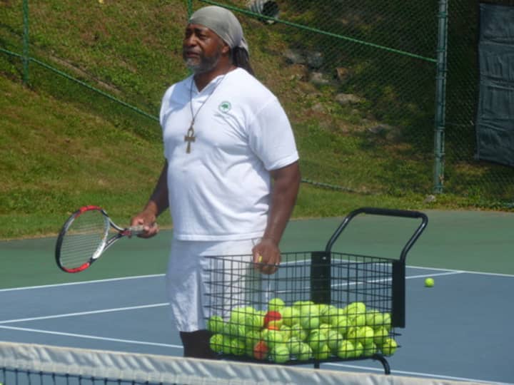 Tennis instructor Joe Boykin serves and volleys with players at the &quot;Celebrate Greenburgh&quot; tennis event. 