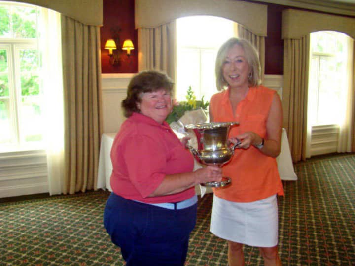 Laurie White holds the North Salem Women&#x27;s Championship Golf Trophy with Cathy Cossari, board member of the Salem Golf
Club.