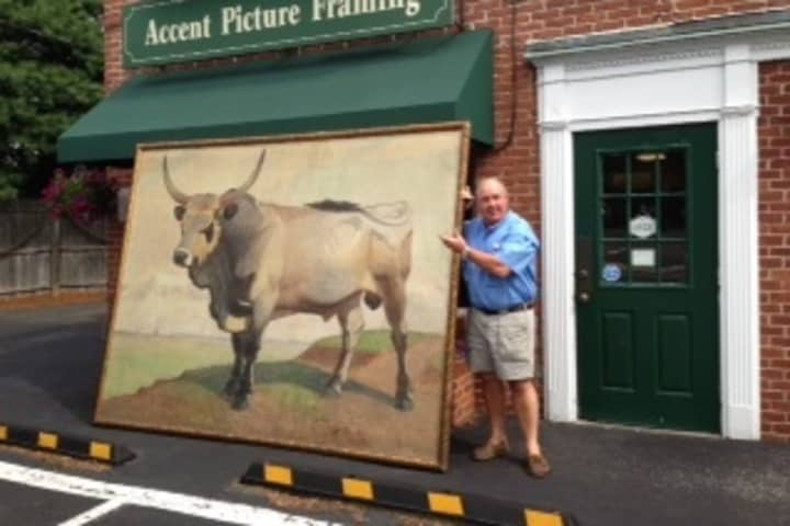 Geary Gallery owner Tom Geary stands with his latest big project, a framed 7 x 9-foot oil painting.