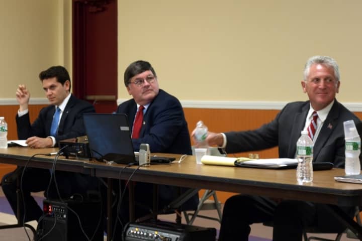 From left: Vinny Mangiacopra, Matt Miklave and Harry Rilling listen to a question during Tuesday&#x27;s mayoral debate at the South Norwalk Community Center.
