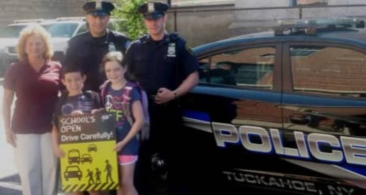 Tuckahoe Police Officers James Kennedy and Philip Magaletti kick off the school safety campaign with Jake and Kayla Yankowski and AAA New York&#x27;s Donna Galasso.
