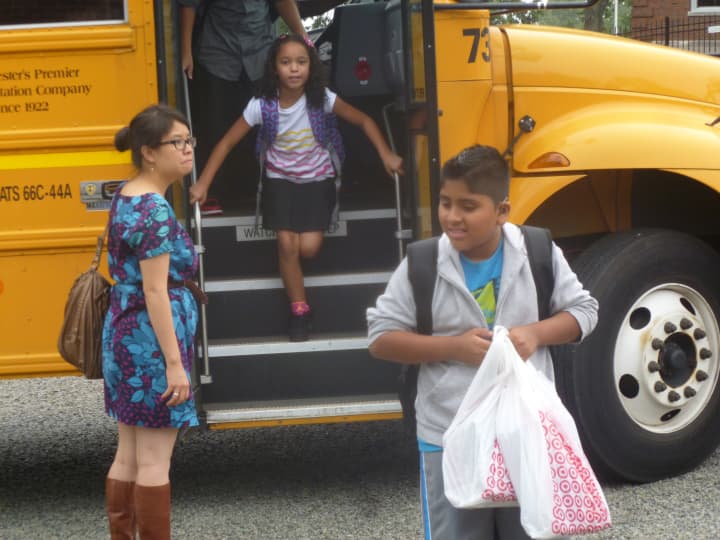Dixson Elementary School students bounce off the bus on opening day of school.