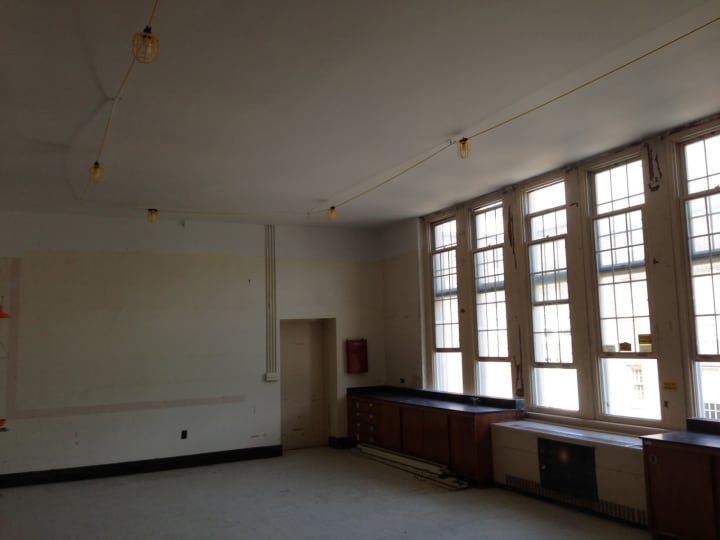 A temporary classroom that has been arranged in the Bronxville Middle School, featuring temporary lights.
