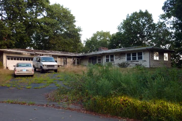 This abandoned, dilapidated  home at 17 Wake Robin Road in Westport is not only an eyesore, neighbors say it presents health and safety issues. 