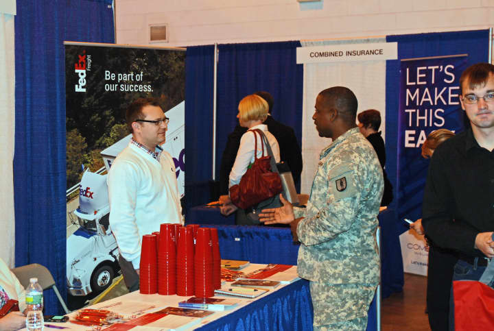 National Guard Sgt 1st Class Byron Barnes speaks with an employer representative during a &quot;Hire our Heroes&quot; job fair in Rochester earlier this year.