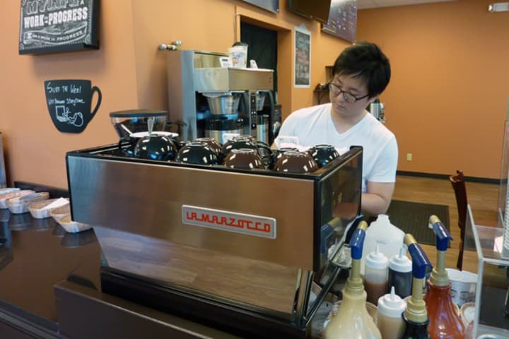 Ridgefield resident Han Lee prepare a beverage at his coffee shop and cafe, Coffee Story, in Wilton. 