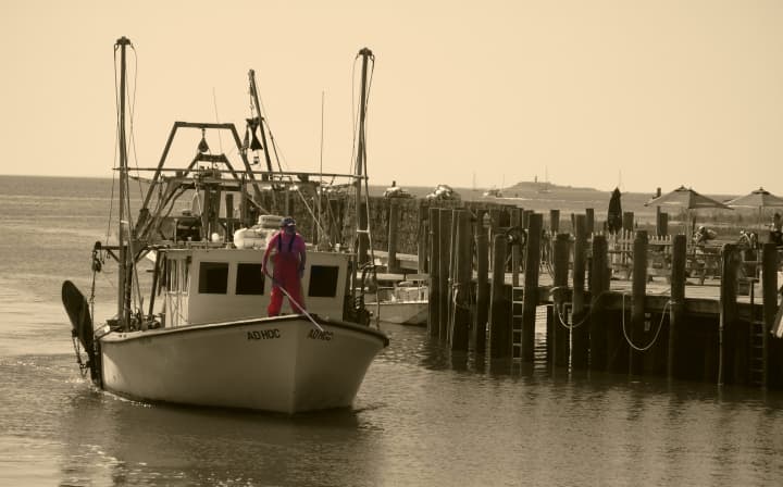 A lobster boat returns to Guilford Harbor along Long Island Sound in Connecticut. 