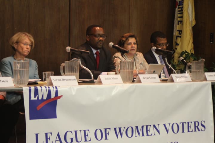 Judith A. Myers, Bryan Greene, Mirza Orriols, and James E. Johnson answer questions at the League of Women Voters forum on the housing settlement.