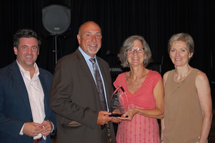 Hastings Public Schools teacher Mary Brewer, second from right, was honored for her 25 years of service at the start of the 2013-14 school year.