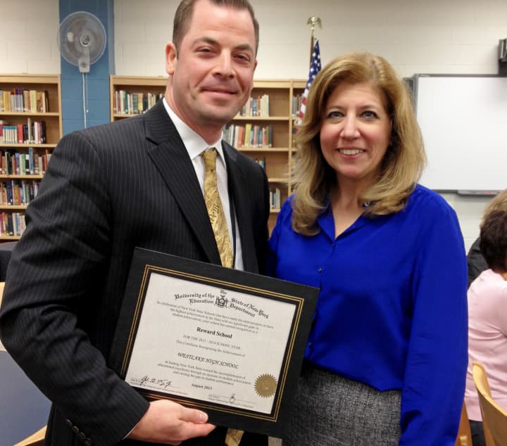 Principal Keith Schenker is presented with the State Education Department certificate recognizing Westlake High School as a high achieving Reward School by Superintendent Dr. Susan Guiney at the September 18 Board of Education meeting.