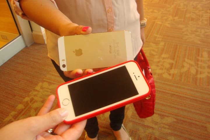 Westchester shoppers show off their new iPhones after the release of the 5s and 5c on Friday.