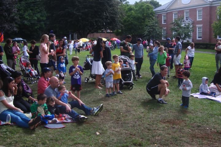 Families congregate on the village green for the 100th birthday party for the Rye Free Reading Room.