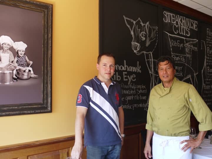 Fairfield restauranteur Patrick Jean and his Head Chef Winnie Togonon in front of the chalkboard and a photo of Jean&#x27;s children, Tristan and Chloe, who the restaurant is named after. 