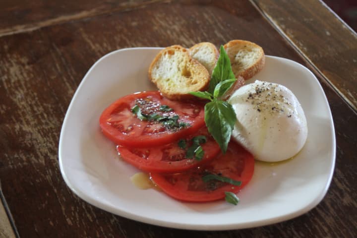 Harvest on Hudson&#x27;s Maple-Brook Farms burrata, made from fresh cow&#x27;s milk and served with grilled bread and fresh tomatoes ($12)