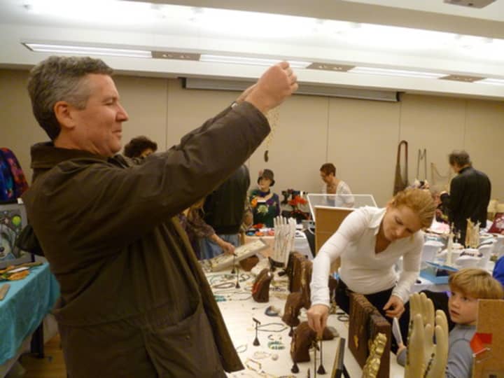 Bruce Robertson eyes some jewelry while looking for Christmas gifts at the Holiday Arts and Crafts Fair in 2011. 