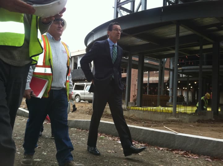 Gov. Dannel P. Malloy walks with construction workers in front of J. M. Wright Technical High School Thursday. A ceremonial groundbreaking was held at the Stamford school that will reopen next year.