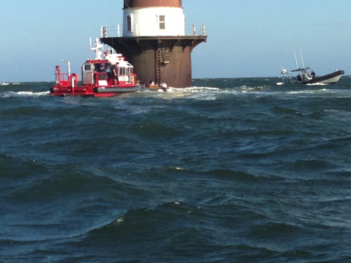 Marine Units from the Norwalk Fire and Police Departments respond to help a boat taking on water near Peck&#x27;s Ledge Lighthouse.