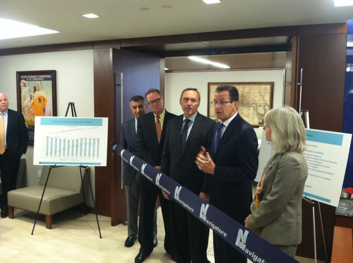 Gov. Dannel P. Malloy gets ready to cut the ribbon as he welcomes Navigators Group Inc. to Stamford on Wednesday morning.