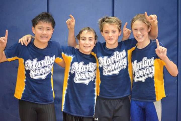 Greenwich YMCA Marlins swimmers, from left, Conway Zhou, Stefan Todorovic, Christian Farricker and Marcus Hodgson celebrate their record-breaking race at a recent meet.