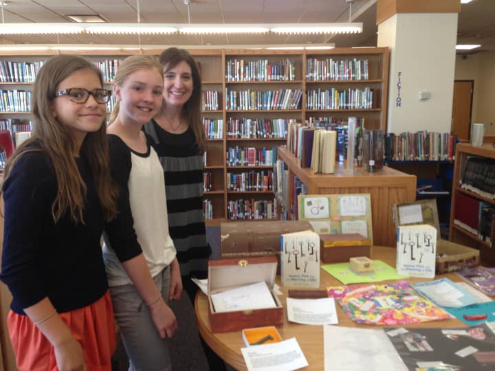 Seventh graders Isabela Fox-Mills, left, and Stella Ard are big fans over Wendy Mass, right, and her book &quot;Jeremy Fink and the Meaning of Life.&quot;