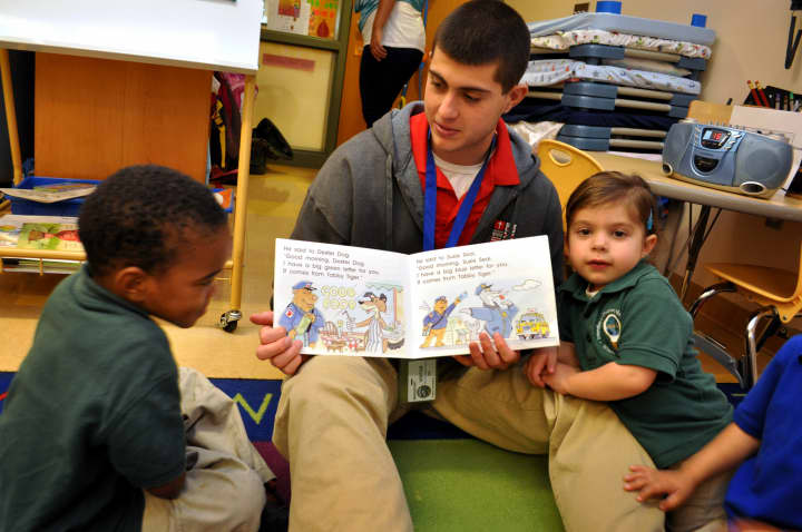 Fairfield&#x27;s Sacred Heart University student Tom Barcia works with students in the Lighthouse Program at the Discovery Cultural Magnet School in Bridgeport.