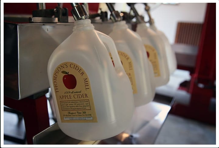 Fresh cider being jugged by the gallon at Thompson&#x27;s Cider Mill. 