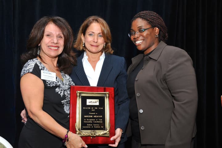 Carol Christiansen, HGAR Awards Committee Chair, left, gives the Realtor of the Year Award to Marcene Hedayati. With them is  Dorothy Botsoe, the HGAR 2012 Realtor of the Year.
 