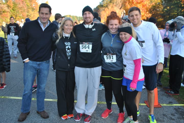 Jason Needle, center, poses with his family and State Sen. Greg Ball, far left, at the first Jason&#x27;s Army 5K in Yorktown.