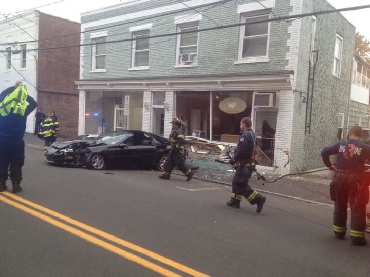 Greenwich firefighters respond after a Camaro slammed into a business on Pemberwick Road. 