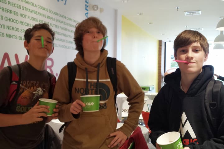 From left, Middlebrook School students Henry Greene, Oliver Peacock and John Fortuna enjoy cookies and cream flavored frozen yogurt at Peachwave in Wilton.