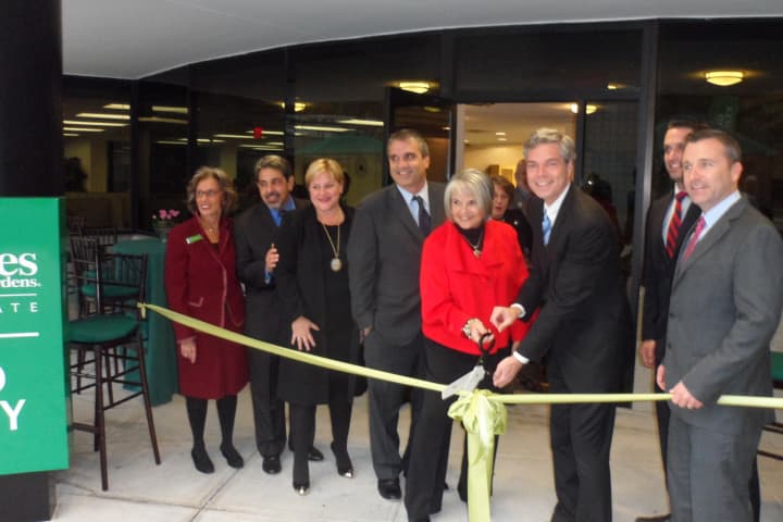 White Plains Mayor Tom Roach and the management team of Better Homes and Gardens Rand Realty cuts the ribbon at its new office in White Plains.