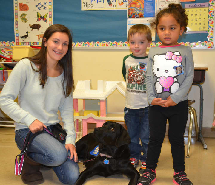 Alyssa Repetto poses with Fiesta, the guide dog she is training, at a recent visit to Lil&#x27; Sprouts Early Learning Center in Peekskill. 