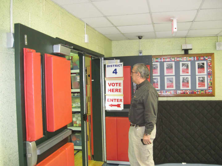 A voter arrives to cast a ballot Tuesday morning at a polling place at New Lebanon School in the Byram section of Greenwich. 
