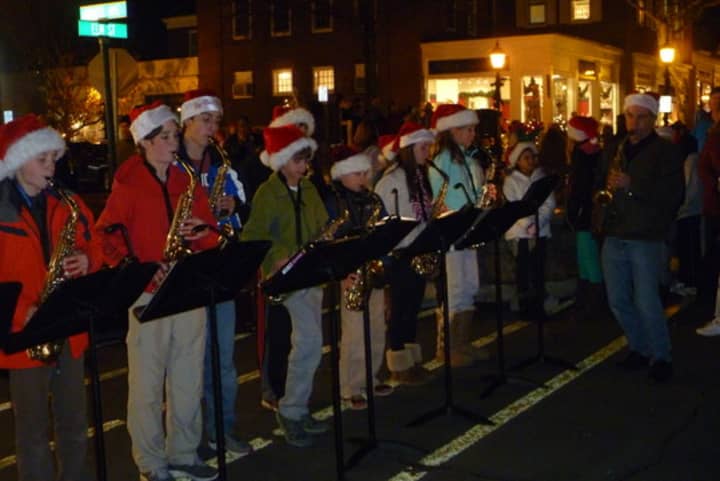 Saxe Middle School students play holiday tunes on their saxophones under the direction of Chris Coulter, right at the 2012 Holidy Stroll. 