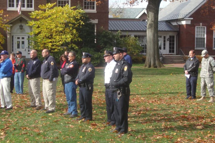 A motorist lost control of her car in a park next to Rye City Hall and the Rye Free Library. In this photo, police officers and veterans gathered on Rye Village Green to watch a ceremony.