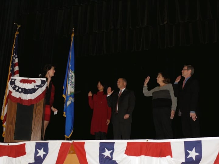 Fairfield Town Clerk Betsy Brown swears in the new members of the Board of Education. 