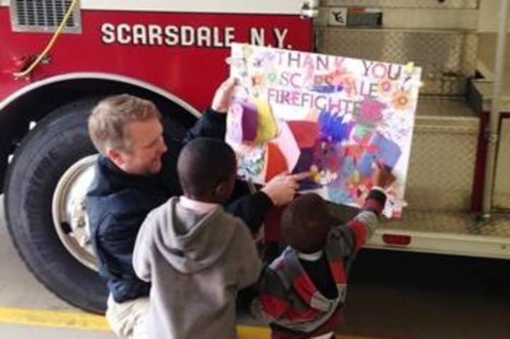 The children of HELP Haven presented Scarsdale firefighter Patrick Gorham a thank you card to show their appreciation to him and his fellow firefighters.