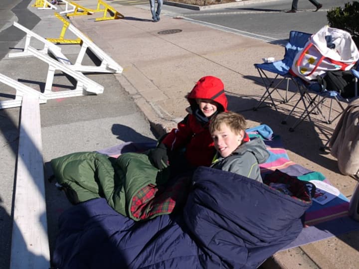 Timmy and William Silkowitz of Stamford brought their sleeping bags to keep warm at the Stamford parade Sunday. 