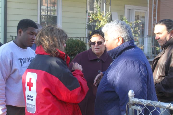 Tamara Garcia-Sanchez, whose home was damaged by the fire, speaks to a Red Cross volunteer. 
